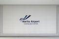 Logo of Tokyo Narita Airport on a white wall