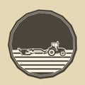 Logo with a tractor plowing