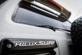 Logo on trunk door of Japanese offroad used white car Toyota Hilux Surf