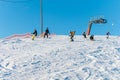 Logoisk. Belarus. 01.11.2023. A group of children snowboarders with a coach descend from a snow-covered mountain