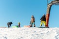Logoisk. Belarus. 01.09.2023. A group of children snowboarders descend from the slope of a snow-covered