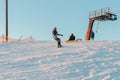 Logoisk. Belarus. 01.13.2023. A group of snowboarders descend from the slope of a snow-covered