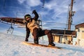 Logoisk. Belarus. 01.12.2023. The guy-snowboarder descends from the slope of a snow-covered mountain