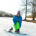 Logoisk. Belarus. 01.15.2023. A snowboarder girl is preparing to descend from a snow-covered mountain in special equipment.