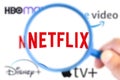 Logotype of 5 leaders of VOD. Highlight of Netflix with a magnifying glass