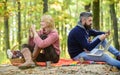 Logout of all accounts. Modern life. Happy loving couple relaxing in park with mobile gadgets. Modern people always