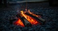 Logs arranged in a triangular shape on a pebble surface, with bright flames and glowi Royalty Free Stock Photo