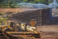 Logs being sprayed with water to prevent insect damage on an extremely hot day - equipment carrying logs - blur due to mist and