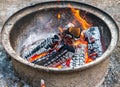 logs burning in fire pit camping flames Royalty Free Stock Photo