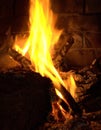 Logs burning in a old brick fireplace Royalty Free Stock Photo