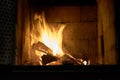 Logs are burning in rare vintage fireplace. Royalty Free Stock Photo