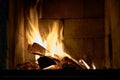 Logs are burning in rare vintage fireplace. Royalty Free Stock Photo