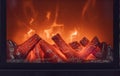 The logs of the fireplace burn with a bright fire. Artificial decorative fireplace with imitation of fire. Closeup photo Royalty Free Stock Photo