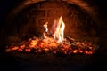 Logs of firewood burn out in the oven. Coals and flames in the fireplace Royalty Free Stock Photo