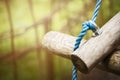 Logs on rope bridge in climbing forest or high wire park on nature sunny background, close up Royalty Free Stock Photo