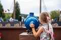 Loifling, Germany - 26 July, 2018: Little girl plays near toy cannon on Pirates of Caribbean attraction in Churpfalzpark