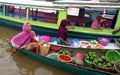 A mother is selling fruits and vegetables at the Lok Baintan floating market