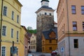 Loket, Czech Republic; 5/20/2019: View of the Black Tower Cerna Vez between some typical colorful buildings, in the picturesque
