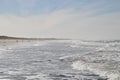 Lokken beach in Denmark with the harbor visible in the distance