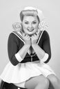 Candy woman in pin-up style. Blonde girl with candies in hands. Beautiful smiled lady with lollipops isolated in studio. Funny pin