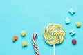 Lollipop design with sugar candys on blue background top view mockup