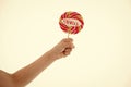 Lollipop with love lettering on white. Candy on stick in hand. Sweet candy swirl. Valentines day concept. Food Royalty Free Stock Photo