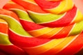 Lollipop multicolored close-up as background texture on pieces on pink background