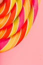 Lollipop multicolored close-up as background texture on pieces on pink background