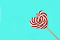 Lollipop in the shape of a heart, on a turquoise background,isolated, Valetine, no people, horizontal, Royalty Free Stock Photo