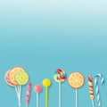 Lollipops and candies. Colorful sweets, festive decoration. Colorful candies on a blue background, top view with copy space for