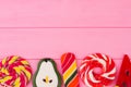 Lollipops candy border on pink wooden background. Royalty Free Stock Photo