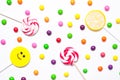 Lollipops, candy smile on, are scattered around the colorful jelly beans