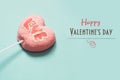 Lollipops pink candy on stick with Love text on blue . Valentine`s card