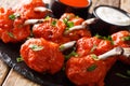 Lollipops Recipe for fried chicken wings with sauces close-up on a slate board on a table. horizontal Royalty Free Stock Photo