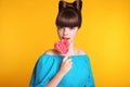 Lollypop. Beauty fashion teen girl with colourful eating colourful lollipop. Happy funny teenage with bow hairstyle isolated on s Royalty Free Stock Photo