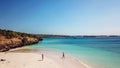 Lombok - A drone shot of a couple playing at the seashore of Pink Beach