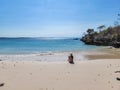 Lombok - A girl sitting at the beach, enjoying the view