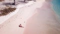 Lombok - Girl in straw hat sitting on pink beach