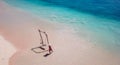 Lombok - A girl swinging on a wooden swing by the seashore