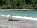 LOMBOK, INDONESIA - CIRCA 2014: A fisherman takes his boat out into the sea on the island of Lombok in indonesia