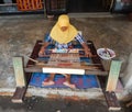 LOMBOK, INDONESIA - CIRCA 2015: A Muslim women weaves a garment using a traditional weaving loom at a village in Lombok, Indonesia