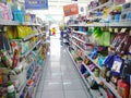 Aisle with various kinds of goods on the shelves inside minimarket