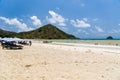 Holidaymakers and surfers on the golden tropical beach of Selong Belanak on the island of