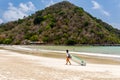 Surfers on the beach of Selong Belanak on the island of Lombok, Indonesia