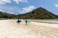 Surfers on the beach of Selong Belanak on the island of Lombok, Indonesia