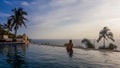 Lombok - A man enjoying the sunset in an infinity pool Royalty Free Stock Photo