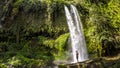 Lombok - A man standing under Tiu Kelep waterfall