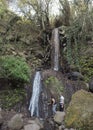 Lomo Magullo, Gran Canaria, Canary Islands, Spain December 25, 2020: Small waterfall at lush landscape of Barranco de