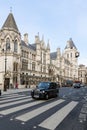 London black cab taxi passing Royal Courts of Justice building