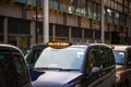 London black cabs lined up on sidewalk waiting for customers Royalty Free Stock Photo